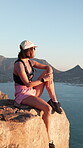 Mountain, thinking and woman on hiking break to relax, rest and ocean view on cliff for calm. Female person, fitness and trekking outdoor with gear, sunglasses and space for exercise and health