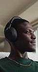 Relax, headphones and black man in home, reflection and listening to music, calm and subscription. Happy, thinking and person in lounge, live streaming for podcast and digital app for radio and sound