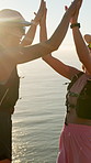 Friends, hiking and women with high five, ocean and celebration for fitness, wellness and support. Seaside, hiker and people with gesture, happiness and excited for challenge, success and exercise