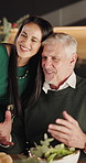 Happy dad, woman or christmas with hug at dinner table for festive feast or celebration in home. Father, adult or smile with embrace for december holiday, family dining or gathering together in house