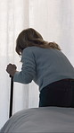 Back, senior woman and walking with stick in bedroom for balance, mobility support or injury recovery. Cane, physical therapy and elderly person with disability, parkinson and rehabilitation at house