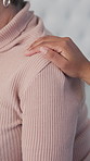 Hand, compassion and nurse with woman in home for consultation, medical support or healthcare. Advice, comfort and caregiver touching shoulder of female patient for trust in nursing facility.