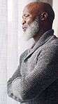 Thinking, sad and black man in home, anxiety and mourning for grief, emotion and contemplation. Remember, stress and senior person with depression, reflection or retirement with window and memory
