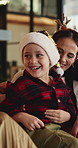 Christmas, girl and people in home, smile and bonding together with holiday, excited and funny. Celebration, family or parent on sofa, daughter and happiness with humor, Xmas or laughing in lounge