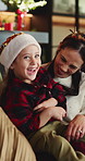 Christmas, girl and family in home, smile and bonding together with holiday, relax and funny. Apartment, people and parent on sofa, daughter and happiness with humor, Xmas and laughing in living room