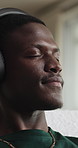Calm, headphones and black man in home, thinking and listening to music, audio and sound. Subscription, contemplation and person in lounge, live streaming for podcast and digital app for radio