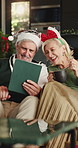 Christmas, video call and couple in home, tablet for online communication and happiness. Xmas, mature man and woman in lounge, smile and tech for virtual chatting, festive season and celebration
