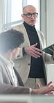 Business, man and meeting with mentor in office for discussion, training and finance advice. Male person, manager or talking with tech for coaching intern, teamwork and feedback on financial proposal