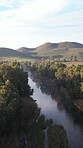 Drone, nature and remote with river in forest for eco tourism, environmental travel or sightseeing. Aerial, landscape and sustainability with water outdoor in natural ecosystem for conservation