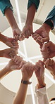 Low angle, fist bump and business people in meeting, investor and support for profit increase. Goals, employees and financial advisor in office, hand gesture or target for trading mission or circle