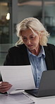 Laptop, document or business woman in office for accounting email, taxes or reading report at night. Computer, mature accountant and paperwork at work for audit, budget review and typing on overtime