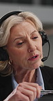 Mature, woman and consultant with headset in office for customer service or online advice. Female person, agent or talking with mic for virtual assistance, support or telecommunication in workplace