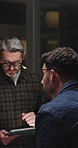 Back, tablet and men in meeting, conversation and planning for company strategy. Business people, evening or employees in office, teamwork or tech for online reading, talk or digital app for schedule
