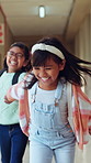 Friends, running and children in hallway at school ready for education, class and learning together. Academy, happy and students in corridor holding hands for knowledge, development and lesson