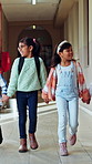 School, walking and girls in hallway holding hands for education, class and learning together. Academy, friends and students in corridor ready for knowledge, development and lesson in morning