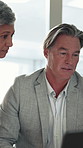 Laptop, mature and business people in office with discussion, email and plan for finance investment. Management, team and talk in workplace with computer, idea and collaboration for funding research.