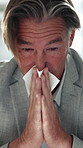 Sick, blowing nose and businessman with tissue in office, allergy season and viral infection for mucus. Influenza, illness and mature employee with hayfever in workplace, sinus and health problem