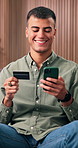 Happy, man and credit card in house with phone, online shopping promotion and payment for purchase. Person, smile and fintech on sofa with mobile app, internet banking and sale on ecommerce website.