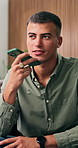 Man, talking and speaker phone in home for online communication, mobile app and social media chat. Person, recording and voice note in living room with digital tech, contact and gossip conversation.