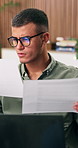 Man, documents and confused with remote work from home with laptop, glasses and review in living room. Person, virtual assistant and admin with paperwork, problem solving or freelance job at house