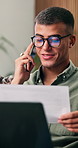 Man, documents and phone call with remote work from home with laptop, glasses and review in living room. Person, virtual assistant and smartphone with paperwork, contact and freelance job at house