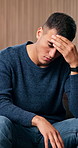 Mental health, thinking or man in home with headache, anxiety trigger or memory of past trauma. Pressure, flashback or person in lounge with migraine, overthinking or fatigue in emotional thoughts.