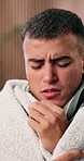 Man, tissue and sick with blanket in home with flu, mucus and virus with fatigue, chills or stress. Person, tired and rest with recovery, healing or cleaning nose for cold, cover and break at house