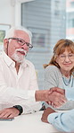 Handshake, office and senior couple with financial advisor for retirement plan, budget and savings. Discussion, finance and elderly people with consultant with thank you on tablet for pension fund