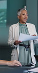 Paperwork, presentation and woman in meeting, planning for investment deal and feedback for profit. Mature person, financial advisor and employee in workplace, talking and documents for economy info