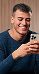 Typing, laughing and man in house with phone, funny chat and post update on social media. Happy, digital gif and male person in home with tech, online communication or meme reaction in text message.