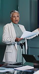 Documents, presentation and woman in office, planning for investment deal and feedback for profit. Mature person, financial advisor and stats report in workplace, talking and speaker for economy info