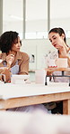 Pottery, women and teacher in workshop with mug, talking or learning process with tips. Ceramic class, creative studio and instructor with cup for art design, teaching technique and handcraft guide