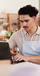 Entrepreneur, typing and man with laptop in ceramic shop, digital marketing and website development. Serious, planning and business owner with pc for customer engagement, pottery sale ads and startup