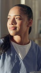 Woman, thinking and nurse with smile at hospital with insight, daydream and inspiration on break. Person, perspective and healthcare professional with reflection, happy or decision with job at clinic