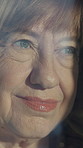 Senior woman, thinking and smile in home at window with memory, insight or daydream for nostalgia. Elderly person, happy and reflection with inspiration, remember and glass at apartment in retirement