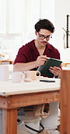 Man, tablet and inspection in art studio with pottery, quality control or stock evaluation for shop. Person, tech and check ceramic mug in workshop with review, inventory and clay for small business.