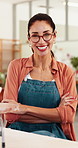 Woman, face and happy with pottery at workshop, arms crossed or manufacturing at small business. Mature person, smile and glasses in portrait for confidence, creative and sculpture at studio in Spain