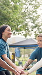 Summer camp, volunteer and people with hands stack for teamwork, collaboration and support. Nature, happy and counselors in huddle for outdoor program, youth facility and ready for camping adventure