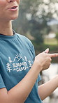 Summer camp, volunteer and woman in nature talking for instructions, rules and teaching for tourism. Forest, happy and counselor with speech for outdoor program, youth facility and camping adventure