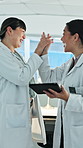 Scientist, high five and happy women with tablet in lab, success and excited for breakthrough or win. Clinic, team and celebration for healthcare achievement, smile and people with medical research