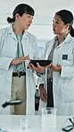 Science, discussion or team in lab with tablet, study review or feedback on experiment report. Teamwork, women or scientist with tech, medical research or partner insight on clinical trial results.