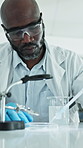 Scientist, chemistry and black man with pipette for medical experiment, drugs development and test. Science, beaker and mature person with dropper in lab for research, chemical or pharma innovation