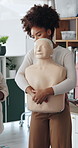 Medical, mannequin and woman with first aid training in office for choking safety demonstration. Healthcare, practice and female person with abdominal compression for simulation on paramedic protocol