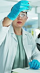 Woman, scientist and liquid with notebook at lab for research, medical study and experiment results. Person, beaker and chemical with observation notes, investigation report or information on vaccine