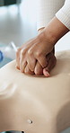 First aid, hands and person with mannequin for cpr training for safety compliance in office. Medical demonstration, healthcare and employee with emergency rescue technique for cardiac arrest.