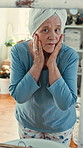 Senior, woman or mirror with lotion for skincare, grooming or anti aging facial treatment in home. Elderly, female person or checking skin with reflection or towel for texture, hygiene or dermatology