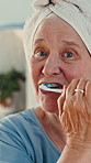 Elderly, woman or brushing teeth with toothbrush in bathroom for dental hygiene or cleaning. Portrait, senior or female person with soap, towel or tooth care for oral, mouth or gum healthcare in home
