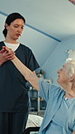 Arm, injury and nurse for old woman with disability, mobility and rehabilitation of motor function. Healing, support and wheelchair with caregiver of senior patient in clinic for checkup or recovery