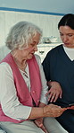 Old woman, discussion and nurse in hospital, tablet for test results and online schedule. Patient, medical service and happy people in clinic, feedback and tech for recovery, healthcare and support