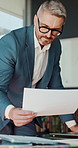 Review, man and laptop with documents in office for data analysis, policy update or forecasting. Finance manager, mature person or tech with statement for financial reporting, compare graphs or stats